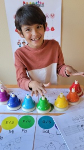 Child playing desk bells